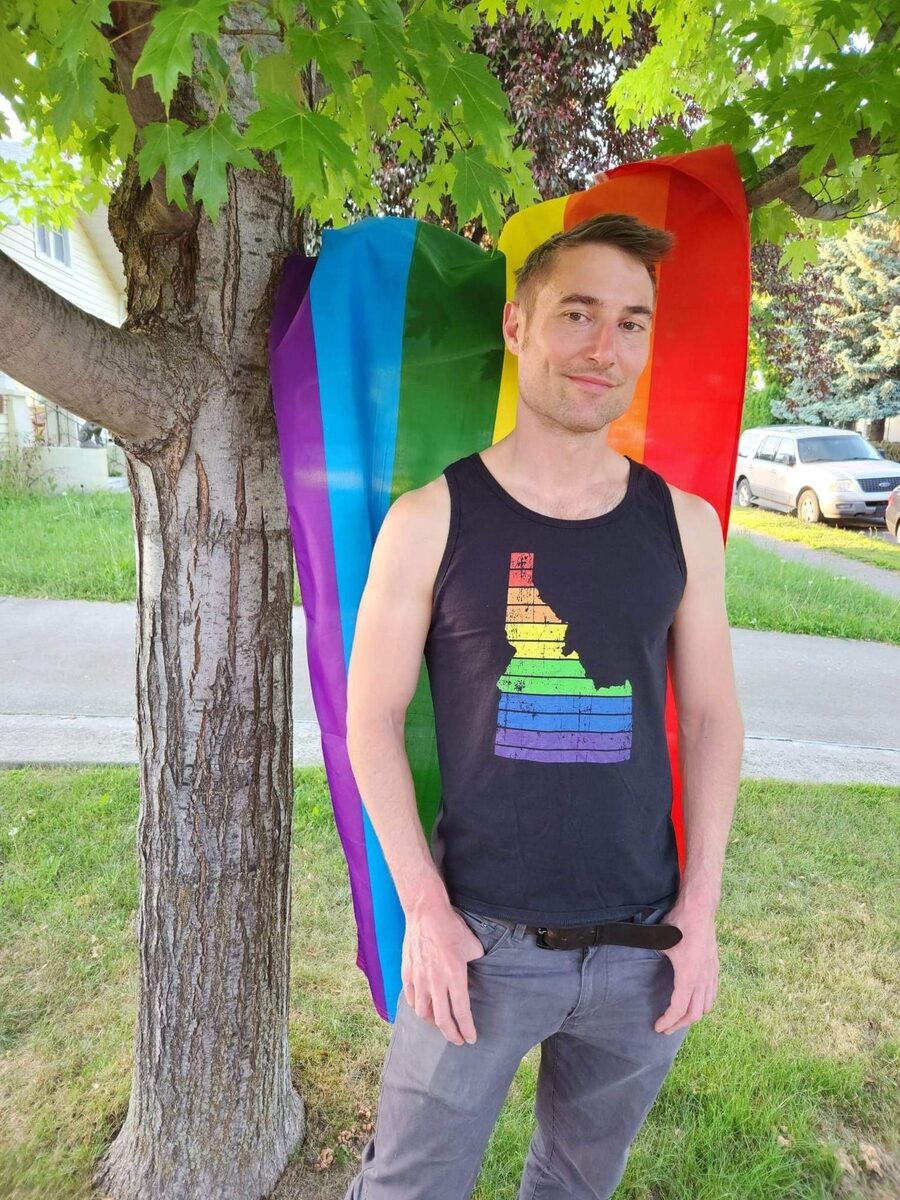 A Spokane Pride community member celebrating with a rainbow flag
